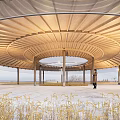 Scenic Circular Open Air Pavilion With Person Walking On Path In Wheat Field