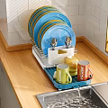 Colorful Tableware Set With Plates Utensils Mugs Teapot On Dish Rack Wooden Countertop