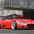 Red Modified Sports Car With Large Rear Spoiler Sleek Body And Industrial Concrete Background