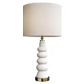 White Spiral Base Table Lamp With Light Fabric Lampshade And Stacked Circular Design