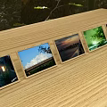 Multiple Photo Frames On Wooden Table Displaying Scenic Landscape