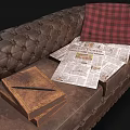 Vintage Tufted Leather Double Sofa With Book Newspapers And Red Plaid Blanket