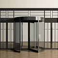Modern Revolving Door With Black Frame And Glass Panels In Minimalist Interior