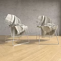 Two Leisure Chairs With Metal Frame And Gray Blanket Against Gray Wall On Wooden Floor