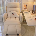 Beige Recliner Chair with Plush Bear Cushion in Cozy Home Office Space Beside White Desk