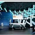 Modern Exhibition Hall With Geometric Decorations Interactive Counter And Blue Lighting 3d model