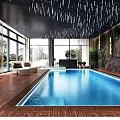 Modern Indoor Swimming Pool With Wooden Flooring Large Windows Green Wall Decorative Ceiling Seating Area