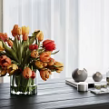 Orange And Red Tulips In Glass Vase On Dark Wooden Table With Small Decorative Items