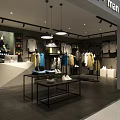 Modern Men's Clothing Store Interior With Various Colored Apparel And Hanging Lights