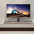 Modern Gray TV Stand With Silver Grille Panel And Small Green Succulent Plant