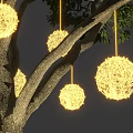 Hanging Round Decorative Lights Illuminated On Tree With Green Leaves