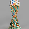 Golden Trophy With Blue Spiral Twisted Design And Colorful Emblem On Top