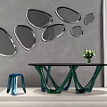 Multiple Irregular Shaped Mirrors On Gray Wall With Black Table Green Legs Blue Stool And Flowers