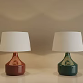Terracotta and Green Ceramic Table Lamps with White Fabric Shades on Beige Table