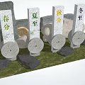 Stone and Wood Crafted Four Solar Terms Steles with Circular Wooden Wheels on Natural Grass