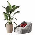 Gray Bean Bag Chair with Red Cushions and Large Green Plant in Woven Basket