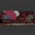 Red Tufted Sectional Sofa with Pink Plaid Blanket Colorful Cushions and Stack of Books