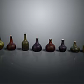 Colored Glass Bottles Neatly Arranged On Gray Background With Various Hues