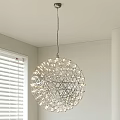 Spherical Metal Frame Chandelier With Small Bulbs Hanging Over White Walls And Window Blinds