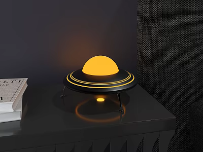Modern UFO Style Lamp with Yellow Spherical Light Black Base on Table with Books 3d model