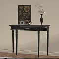Black Console Table With Decorative Vase And Floral Wall Art