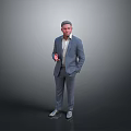 Man in Gray Suit Holding Red Object Standing Against Gray Background