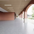 Office Corridor With Red Brick Walls Arched Doorways Wooden Ceiling And Gray Terrazzo Floor