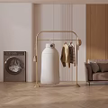 Golden Clothes Rack with Hanging Clothes and Dryer Near Washing Machine in Modern Interior