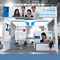 FLEXSPACE Coworking Exhibition Booth with Blue White Design Display Screens People Photos and Interacting