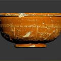 Artistic Orange Carved Bowl Sculpture With Textured Surface On Gray Background