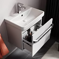 Wall Mounted White Washbasin with Round Backlit Mirror Orange Towels Side Table Toiletries and Plant
