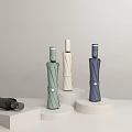 Stylish Foldable Umbrellas In Various Colors On White Display Stands