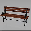 Red Wooden Park Bench With Black Metal Armrests In Natural Setting