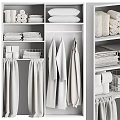 Organized White Wardrobe Interior With Hanging Garments Folded Towels And Storage Shelves