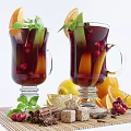 Homemade Red Beverage In Glasses With Orange Lemon Slices Cranberries Cinnamon Sticks And Mint Leaves