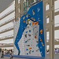 Indoor Rock Climbing Wall With Colorful Holds For Fitness Workout People Climbing In Mall