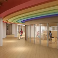 Colorful Indoor Space Featuring Rainbow Curved Ceiling Wooden Floor And People Activities