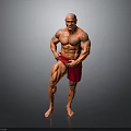 Muscular Man Posing to Showcase Well Developed Muscles in Red Shorts