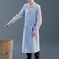 Man in Long Light Blue Apron and Long Sleeve Shirt Pointing at Open Cardboard Box