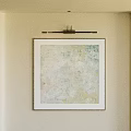 Abstract Painting in Black Frame Hanging on Beige Wall with Spotlight Light Blue Yellow Tones