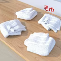 White Towels Neatly Folded on Wooden Surface Soft and Absorbent for Daily Use