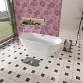 White Bathtub in Bathroom With Pink Floral Wallpaper and Black White Checkered Floor Tiles
