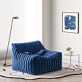 Blue Ribbed Bean Bag Chair with Side Table Plant Floor Lamp and Abstract Painting
