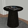 Round Black Wooden Coffee Table With Conical Base And Magazine Pinecones On Rug