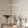 Georg Jensen Artistic Silver Vases With White Blooms On Elegant Paneled Walls