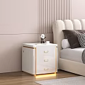 White Nightstand With Gold Accents Next To Beige Upholstered Headboard In Pink Striped Wall Bedroom