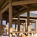 Traditional Open Wooden Pavilion Featuring Green Tiled Roof And Stone Surroundings