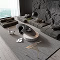 Modern Sofa Coffee Table Set With Stone Wall Plush Pillows Floor Lamp And Textured Rug