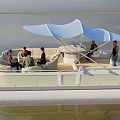Relaxing Pontoon Boat With Blue Canopy And People Enjoying Activities On Water