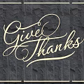 Neon Lighting Combination With Give Thanks Lettering And Border On Dark Stone Wall